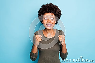 Portrait of funny funky mulatto girl raise fists watch football match please want her team win hope they score goal wear Stock Photo