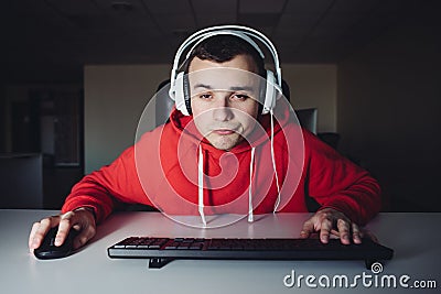 Portrait of funny gamer plays games on his computer. Young gamer uses your computer. A young man uses the computer Stock Photo