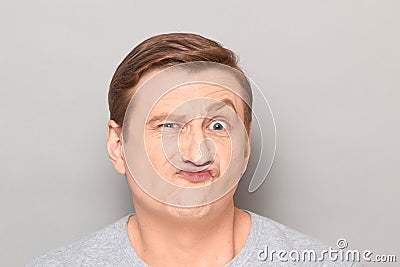 Portrait of funny man grimacing and making goofy crazy face Stock Photo