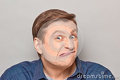 Portrait of funny man grimacing and making goofy crazy face Stock Photo