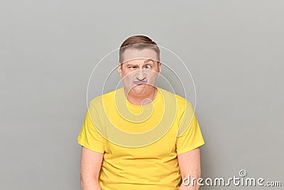 Portrait of funny puzzled mature man making goofy crazy face Stock Photo