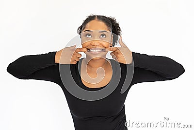 Portrait of funny young woman pulling lips in false smile Stock Photo