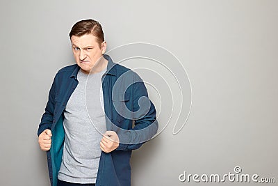 Portrait of furious annoyed blond mature man with angry expression Stock Photo