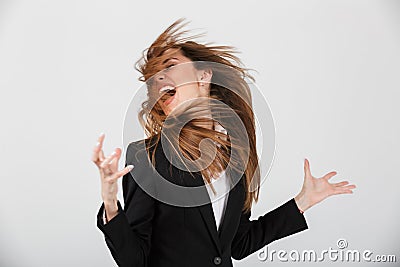 Portrait of a furious businesswoman dressed in suit screaming Stock Photo