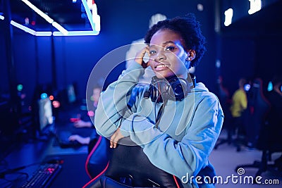 Portrait Gamer African American beautiful woman play online games computer, streamer neon room Stock Photo