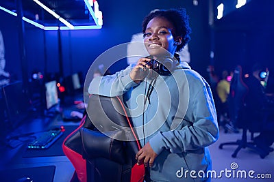 Portrait Gamer African American beautiful woman play online games computer, streamer neon room Stock Photo