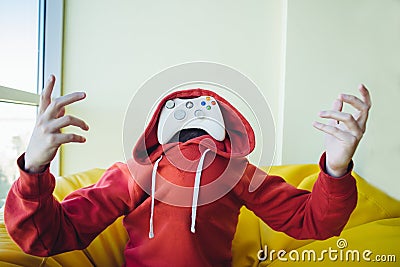 Portrait of a gamer is instead face a joystick for video games. The concept of video games. Stock Photo