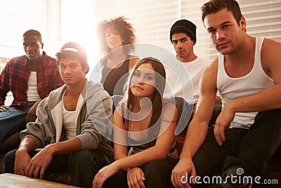 Portrait Of Gang Members Sitting On Sofa In House Stock Photo