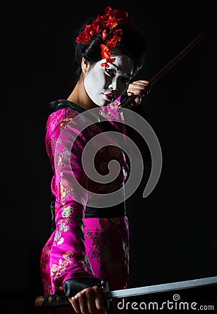 Portrait of geisha holding sword Stock Photo