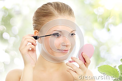 Portrait of a girl applying mascara Stock Photo