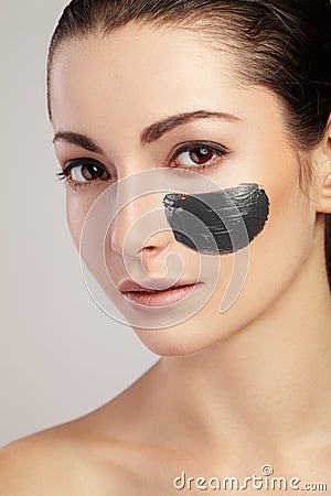 Portrait of girl with black clay smear on the cheek Stock Photo