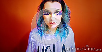 Portrait of a girl with blue hair in a very colorful make-up. Stock Photo