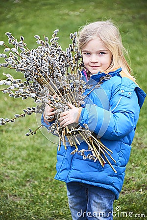 Portrait Girl with a branch of willow. Salix. Easter traditions. Stock Photo