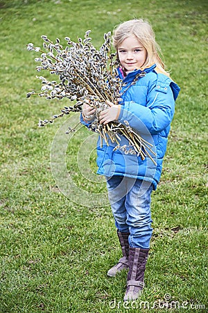 Portrait Girl with a branch of willow. Salix. Easter traditions. Stock Photo