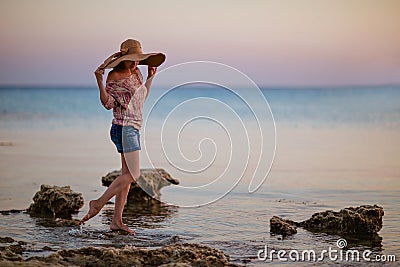 Portrait of a girl in a broad-brimmed hat on the background of t Stock Photo