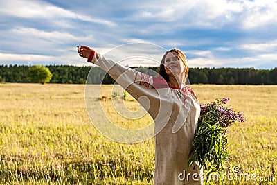 Portrait of a girl with a bunch of willow-herb in a green field Stock Photo