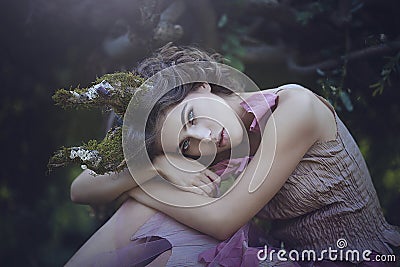 Portrait of girl enchanted Princess with horns. Girl Mystical creature fawn in shabby clothes in a fairy forest Stock Photo