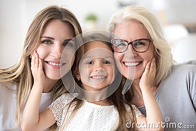 Portrait of girl hugging mom and grandmother making family pictu Stock Photo