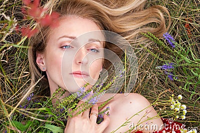 Portrait of a girl with a roof plan. Beautiful girl among the grass and color. Portrait of a girl on the shoulders Stock Photo