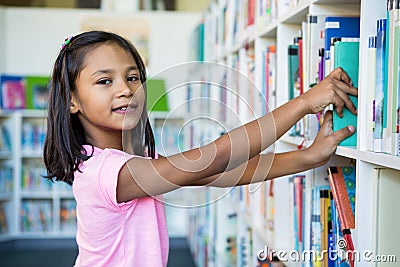 Portrait of girl searching books in school library Stock Photo