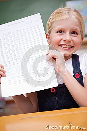 Portrait of a girl showing her school report Stock Photo