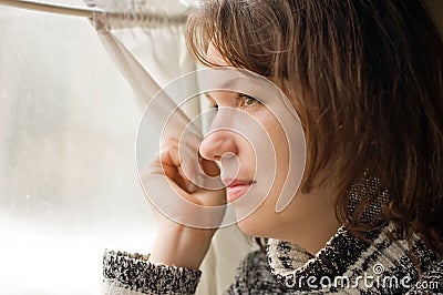 Portrait of Girl in train looks out of window Stock Photo