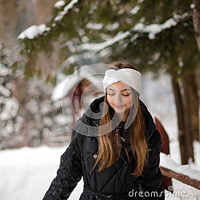 Portrait of a girl in winter clothes with white gloves and a white headband. Stock Photo