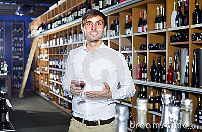 Portrait of glad male customer tasting wine before purchasing it Stock Photo