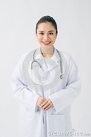Portrait of glad smiling doctor in white uniform standing with crossed hands on white background Stock Photo