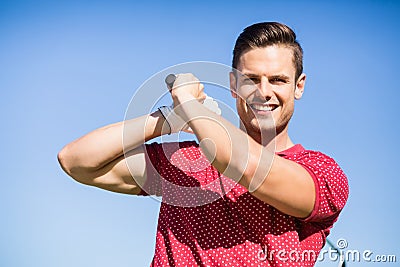 Portrait of golfer man taking shot Stock Photo