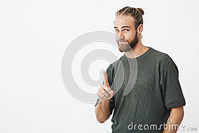 Portrait of good-looking nordic man showing index finger asking to wait for a minute while he clean hands in toilet Stock Photo