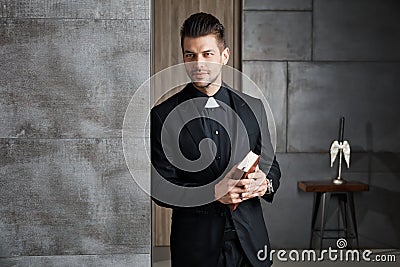 Portrait of good-looking young catholic priest Stock Photo