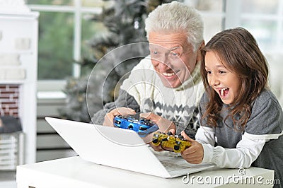 Portrait of grandfather and child with laptop Stock Photo