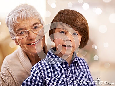 Portrait, grandmother and Christmas with a boy, child and festive season with hug and family. Face, embrace and elderly Stock Photo