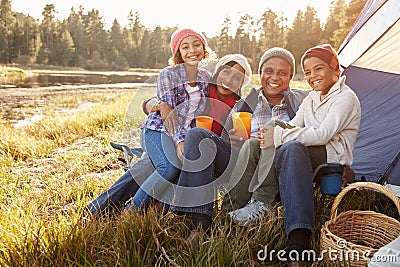 Portrait Of Grandparents With Children Camping By Lake Stock Photo