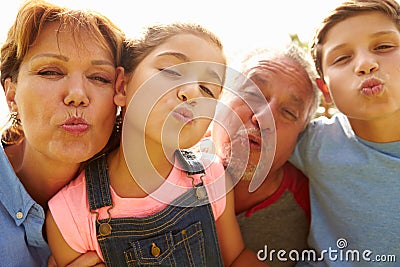 Portrait Of Grandparents And Grandchildren In Garden Stock Photo