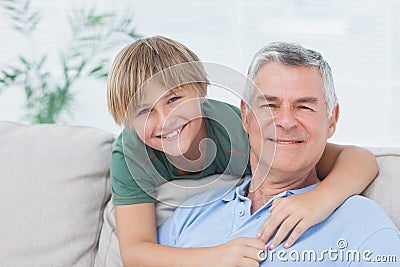Portrait of grandson embracing grandfather Stock Photo