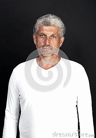 Portrait of a gray-haired middle-aged man on a black background Stock Photo