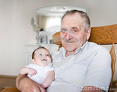 Portrait of great grandfather holding newborn baby Stock Photo