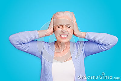 Portrait of grey haired old nice beautiful annoyed woman with palms on head. Isolated over violet purple background Stock Photo