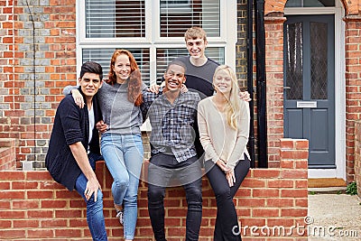 Portrait Of Group Of Smiling College Students Outside Rented Shared House Stock Photo