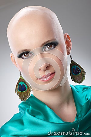 Portrait of hairless woman in turquoise silk dress Stock Photo