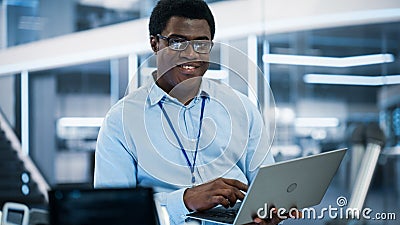 Portrait of a Handsome African Man Wearing Smart Corporate Wear and Glasses, Looking at Camera and Stock Photo