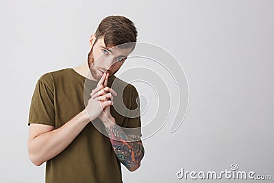 Portrait of handsome attractive mature bearded tattooed caucasian man with short brown hair in casual brown tshirt Stock Photo