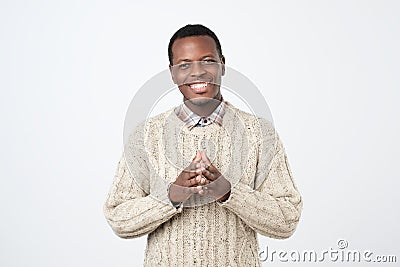handsome black man in warm sweater isolated on a white background. Positive facial emotion Stock Photo