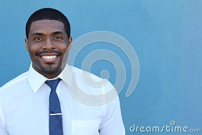 Portrait of handsome confident young African businessman standing smiling happy, looking at camera Stock Photo