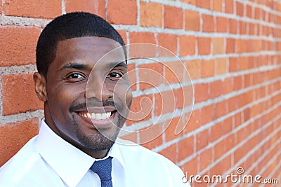 Portrait of handsome confident young African businessman standing smiling happy, looking at camera Stock Photo