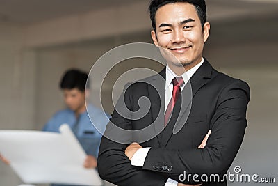 Portrait of handsome confident young businessman smiling Stock Photo