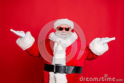 Portrait of handsome cool funny santa claus with eyeglasses holding newyear ads promo wearing black belt cap isolated Stock Photo