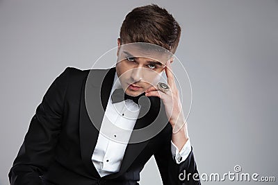 Portrait of handsome elegant man with golden ring thinking Stock Photo